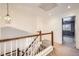 Bright hallway with hardwood stairs and decorative lighting leads to an upper level room at 2228 Gold Dust Trl, Highlands Ranch, CO 80129