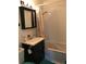 Compact bathroom featuring a vanity with storage, a jacuzzi bathtub, and tiled walls at 5618 Carr St, Arvada, CO 80002