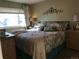 Cozy bedroom with a large window, patterned bedding, and ample natural light at 5618 Carr St, Arvada, CO 80002