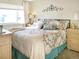 Bright bedroom featuring a large bed with decorative pillows and sunlight from the windows at 5618 Carr St, Arvada, CO 80002