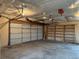 Large garage with shelving and garage door ready for vehicle parking and storage at 5618 Carr St, Arvada, CO 80002