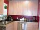 Bright kitchen featuring maple cabinets, stainless steel appliances, dark countertops, and ample countertop space at 5618 Carr St, Arvada, CO 80002