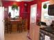 Bright eat-in kitchen with light wood cabinets, black appliances, and a breakfast nook with windows at 5618 Carr St, Arvada, CO 80002