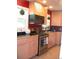 Well-lit kitchen featuring stainless steel appliances, neutral countertops and maple cabinets at 5618 Carr St, Arvada, CO 80002