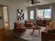 A brightly lit living room with stylish mid-century modern furnishings and hardwood floors at 5618 Carr St, Arvada, CO 80002