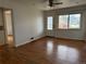 Spacious living room featuring hardwood floors and abundant natural light from a front-facing window at 5618 Carr St, Arvada, CO 80002