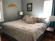 Cozy bedroom with a queen bed, neutral decor, and soft lighting from a nearby window at 5618 Carr St, Arvada, CO 80002