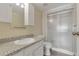 This bathroom showcases granite counters, a shower, sleek vanity and ample natural light at 13850 E Marina Dr # 506, Aurora, CO 80014