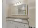 Well-lit bathroom with vanity, granite countertop, white cabinets, and stylish mirror at 13850 E Marina Dr # 506, Aurora, CO 80014