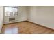 Cozy bedroom featuring hardwood floors, a window, and ample natural light at 13850 E Marina Dr # 506, Aurora, CO 80014