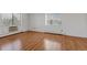 Bright bedroom showcasing laminated floors, large windows, and baseboard heaters for comfort at 13850 E Marina Dr # 506, Aurora, CO 80014