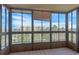 Enclosed patio with view of trees, sky, and adjacent buildings through windows at 13850 E Marina Dr # 506, Aurora, CO 80014