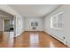 Bright living room with a balcony, laminate flooring, and two windows letting in tons of natural light at 13850 E Marina Dr # 506, Aurora, CO 80014