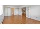 Bright living room features gleaming hardwood floors, a large window, and closet for ample storage at 13850 E Marina Dr # 506, Aurora, CO 80014