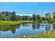 Scenic pond with ducks, mature trees, and buildings in the background of the community at 13850 E Marina Dr # 506, Aurora, CO 80014