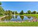 Scenic pond with a fountain, surrounded by trees and lush green grass at 13850 E Marina Dr # 506, Aurora, CO 80014