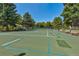Wide view of community tennis court with benches and surrounding greenery and landscaping at 13850 E Marina Dr # 506, Aurora, CO 80014