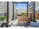 Outdoor dining area with a modern wood pergola and outdoor seating at 6364 Fulton St, Denver, CO 80238