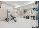 Spacious basement gym with neutral walls, plush carpet, and state of the art workout machines at 6364 Fulton St, Denver, CO 80238