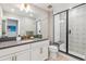 Modern bathroom featuring a vanity with a gray countertop and glass-enclosed shower with seat at 6364 Fulton St, Denver, CO 80238