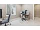 Bright room featuring an egress window and desk and chair setup with overhead lighting at 6364 Fulton St, Denver, CO 80238