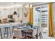 Elegant dining area with modern decor, stylish chandelier, and convenient access to the kitchen at 6364 Fulton St, Denver, CO 80238