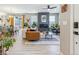 Inviting living room featuring a modern fireplace, stylish furnishings, and hardwood floors at 6364 Fulton St, Denver, CO 80238
