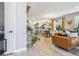Bright, open-concept living space with hardwood floors, modern furnishings, and a view into the kitchen at 6364 Fulton St, Denver, CO 80238