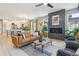 Cozy living room with a contemporary fireplace, comfortable seating, and an open flow to the kitchen at 6364 Fulton St, Denver, CO 80238