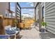 Cozy outdoor patio with wooden pergola, dining set, and modern decor, perfect for entertaining at 6364 Fulton St, Denver, CO 80238