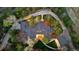 An aerial view of an estate showcasing the roofline, driveway, landscaping, and surrounding trees at 1 Greenridge Rd, Greenwood Village, CO 80111