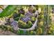 Aerial view of a secluded home with a private driveway, well-manicured lawn, and mature trees at 1 Greenridge Rd, Greenwood Village, CO 80111