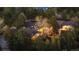 Stunning aerial view of a secluded house featuring mature trees and a separate guest house at 1 Greenridge Rd, Greenwood Village, CO 80111