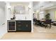 View of the dining room with a wine fridge, decorative mirror, and view into dining area at 1 Greenridge Rd, Greenwood Village, CO 80111