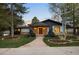 Charming single-story home with stone accents, a brick pathway, and beautifully landscaped front yard at 1 Greenridge Rd, Greenwood Village, CO 80111