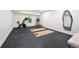 Home gym area complete with exercise bike, yoga mats and full length mirror at 1 Greenridge Rd, Greenwood Village, CO 80111