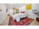 Bright bedroom with hardwood floors, white linens, and ample natural light highlighting the cozy atmosphere at 1 Greenridge Rd, Greenwood Village, CO 80111