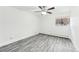 Bright bedroom with wood-look floors and ceiling fan at 5995 W Hampden Ave # 5I, Denver, CO 80227