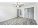 Bedroom with gray sliding doors and wood-look floors at 5995 W Hampden Ave # 5I, Denver, CO 80227