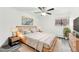 Virtually staged bedroom with a king-size bed, ceiling fan, and wood-look floors at 5995 W Hampden Ave # 5I, Denver, CO 80227