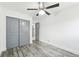 Bedroom with gray sliding doors and wood-look floors at 5995 W Hampden Ave # 5I, Denver, CO 80227