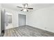 Bedroom with gray sliding doors and wood-look floors at 5995 W Hampden Ave # 5I, Denver, CO 80227