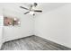 Simple bedroom with gray wood-look floors and ceiling fan at 5995 W Hampden Ave # 5I, Denver, CO 80227