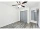 Bedroom with gray sliding doors and wood-look floors at 5995 W Hampden Ave # 5I, Denver, CO 80227