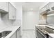 Modern kitchen with gray cabinets and stainless steel appliances at 5995 W Hampden Ave # 5I, Denver, CO 80227