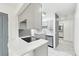 Updated kitchen featuring gray cabinets, quartz countertops, and a breakfast bar at 5995 W Hampden Ave # 5I, Denver, CO 80227