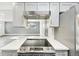 Modern kitchen with stainless steel appliances and white quartz countertops at 5995 W Hampden Ave # 5I, Denver, CO 80227