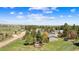 Spacious green lot with charming house, outbuildings, and a fenced yard near treed neighborhood at 1151 Buttercup Rd, Elizabeth, CO 80107