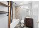 Bathroom with bathtub, shower with grey tile, wood shelves, gray walls, and wood look floor at 1151 Buttercup Rd, Elizabeth, CO 80107