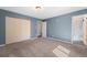 Spacious bedroom with closet, carpet, and blue walls at 1151 Buttercup Rd, Elizabeth, CO 80107